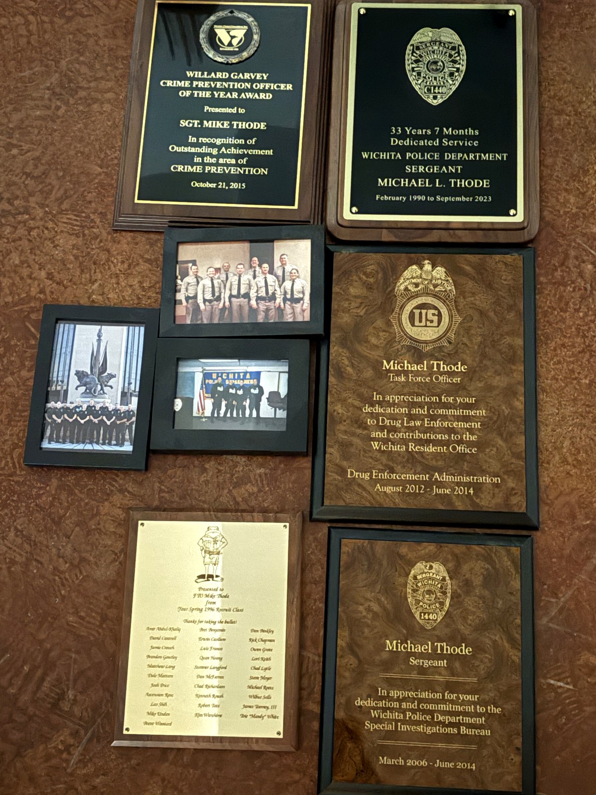 Mike Thode's career plaques and photographs: Crime Prevention Officer of the Year, 33 years of dedicated service, DEA task force and Special Investigations Bureau awards